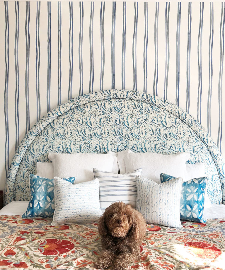 Double Inky Stripe • Striped Wallpaper • Blue Striped Wallpaper Rolls • Georgia MacMillan • Milton & King UK • Bedroom wallpaper showing a bed with a brown dog