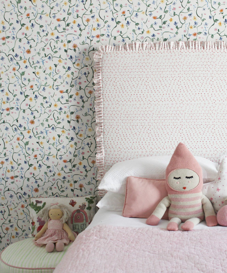 Wild Garden • Dainty Floral Wallpaper • Milton & King UK • Georgia MacMillan • Childrens Wallpaper • Nursery Wallpaper • Bed with pink headboard and pink duvet