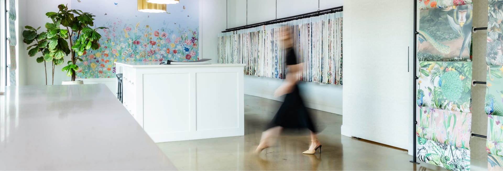 Woman walking through Milton & King wallpaper showroom